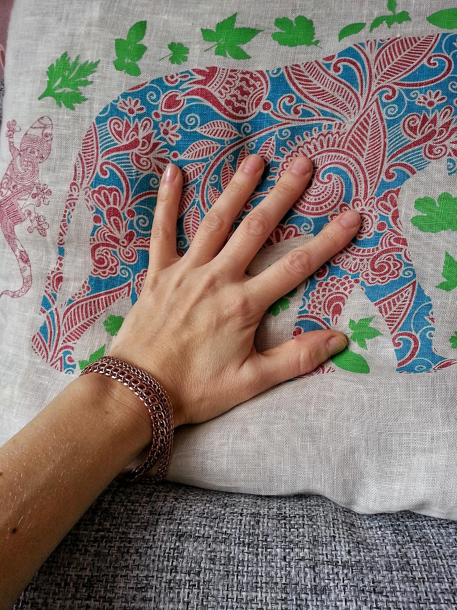 Artisan hands embroidering a patch